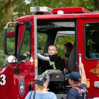 little boy in the drivers seat of a grand rapids fire department truck